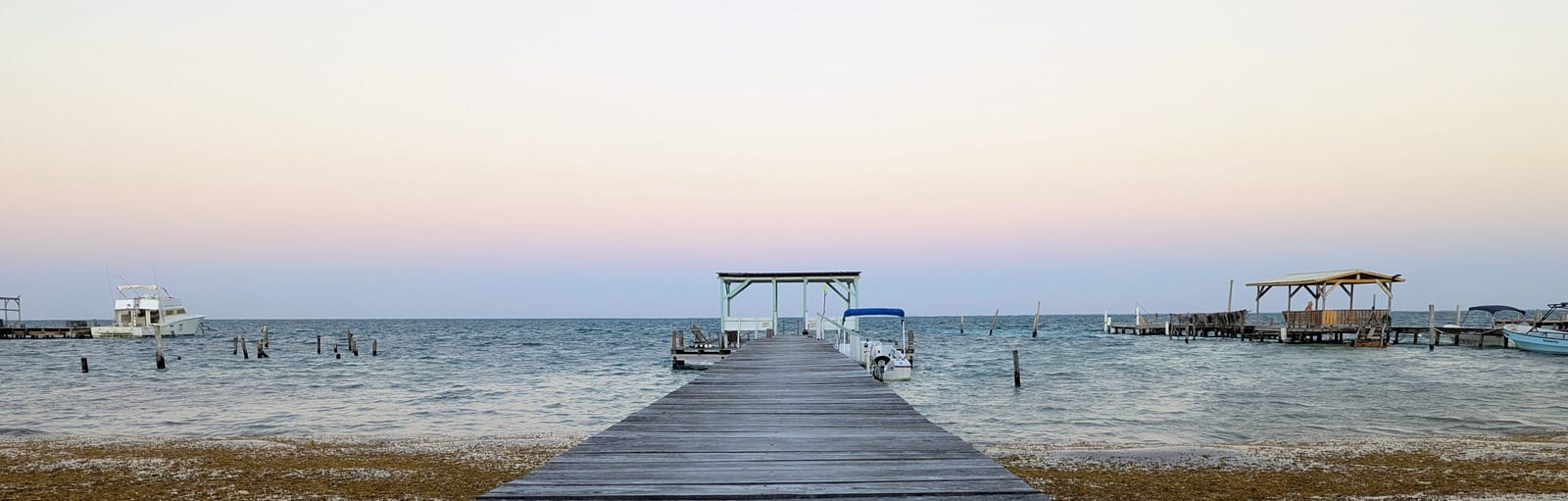 Morning pier and calm sea on Caye Caulker