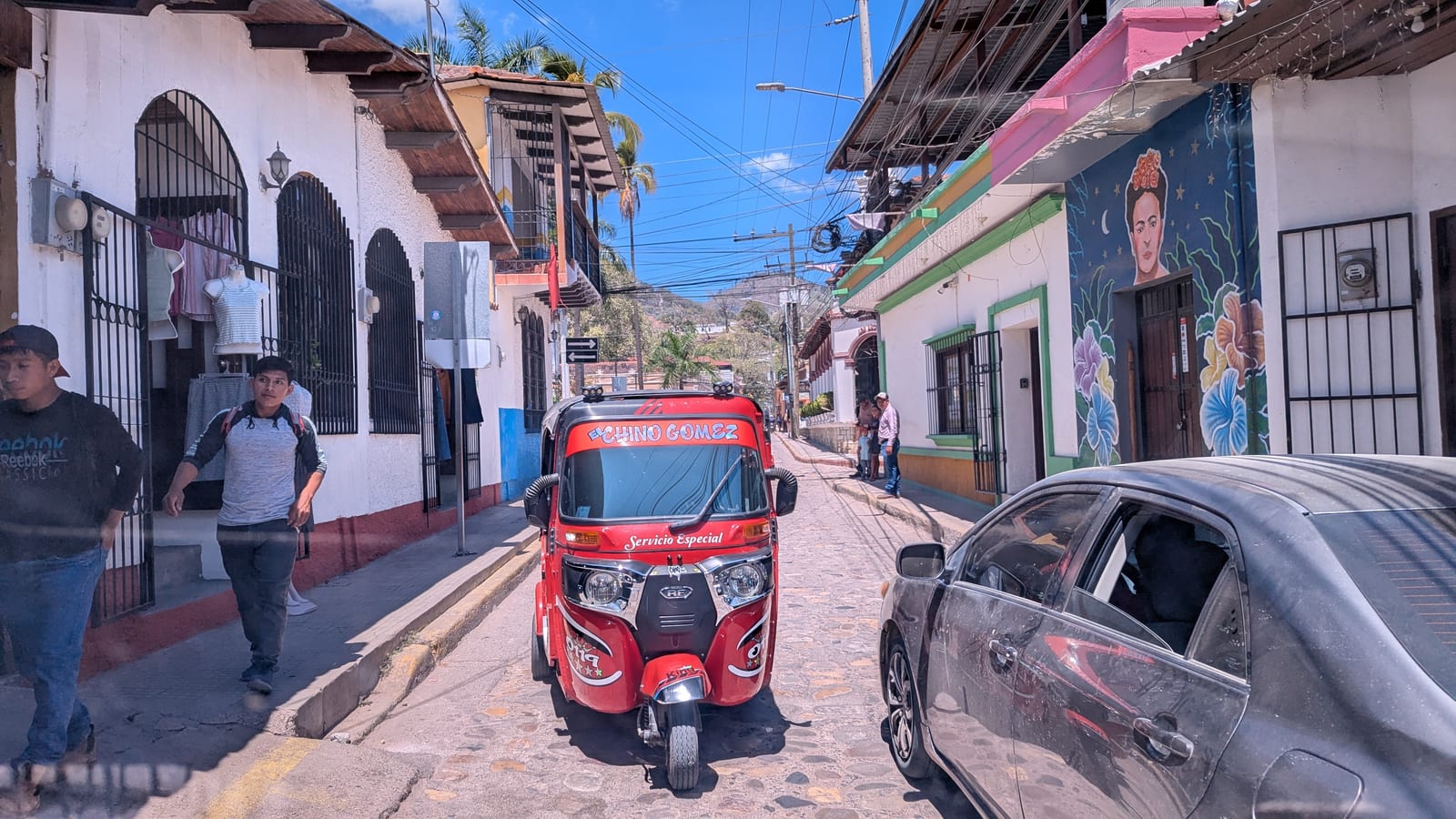 A cobbled street in Copan Ruinas with low colonial buildings
