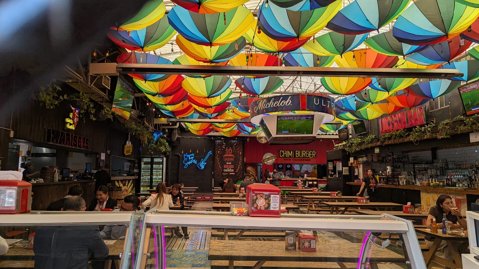 Colorful umbrellas over a Mexico City market or food hall