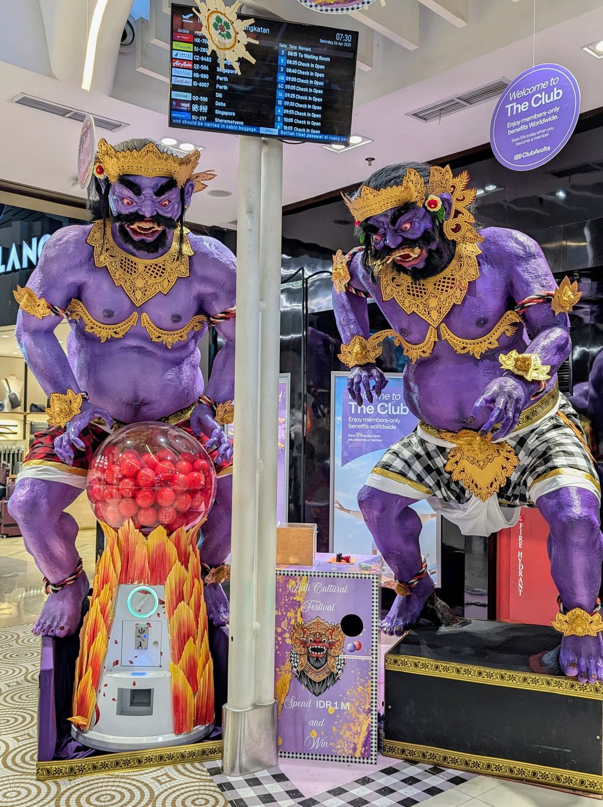 Large purple demon statues decorating a Denpasar shopping mall