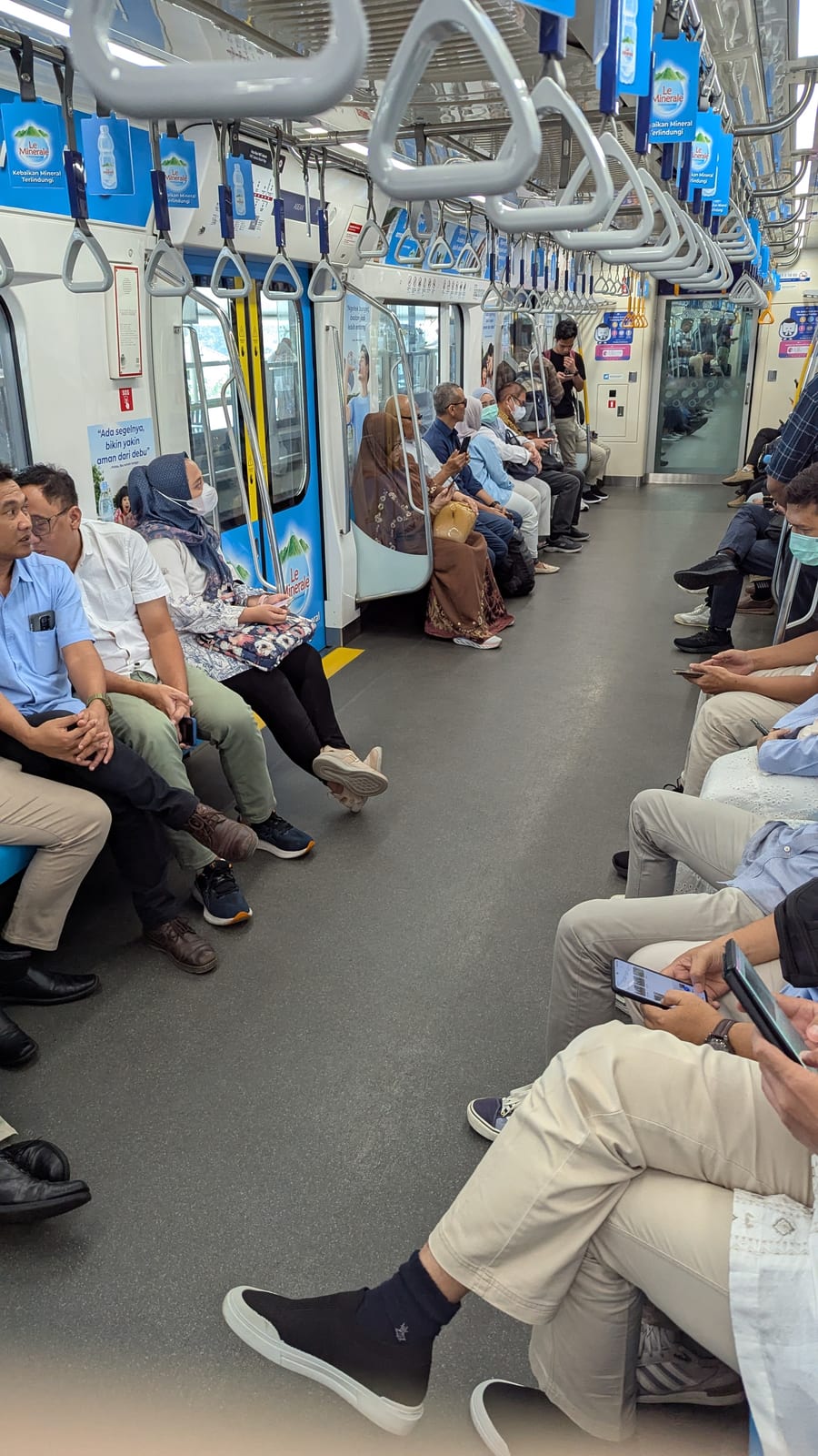 Commuters riding a packed Jakarta MRT train car