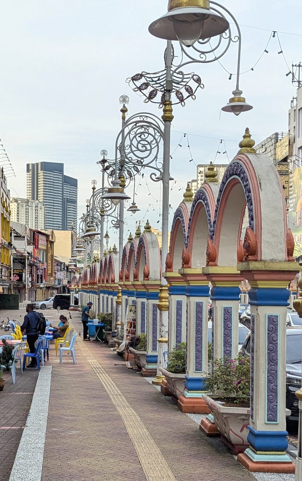 Ornate lamp posts and arcades along a Little India street in Kuala Lumpur