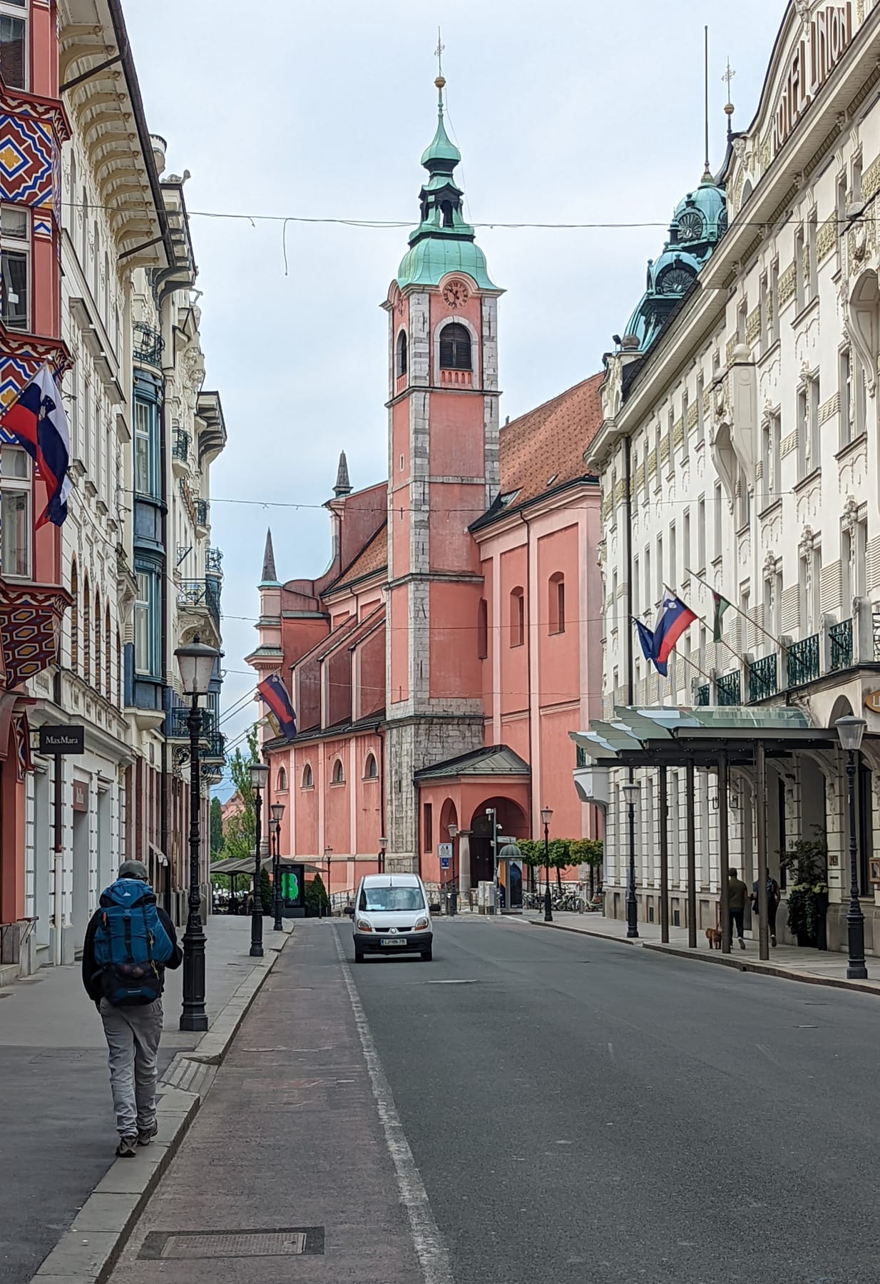 Colorful historic buildings and flags along a street in central Ljubljana